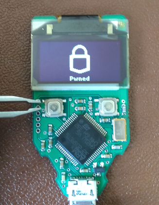 TREZOR with label 'Pwned' and tweezers